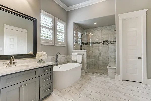 a bathroom with a double vanity sink mirror and shower