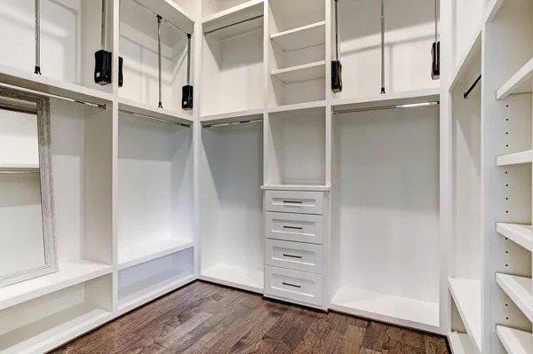 a view of walk in closet with empty racks