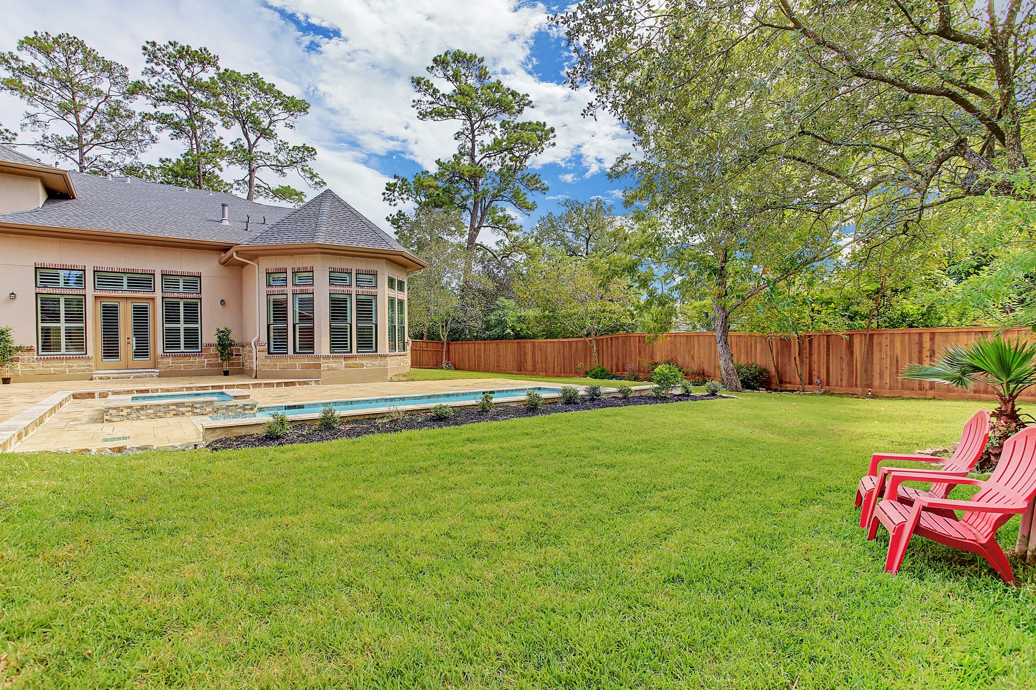 325 Bunker Hill Road Houston, TX 77024 - Photo 49 of 50 a backyard of a house with table and chairs