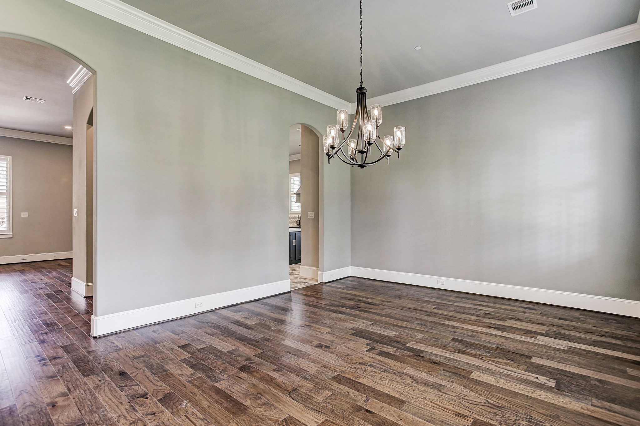 325 Bunker Hill Road Houston, TX 77024 - Photo 7 of 50 an empty room with wooden floor chandelier and entryway