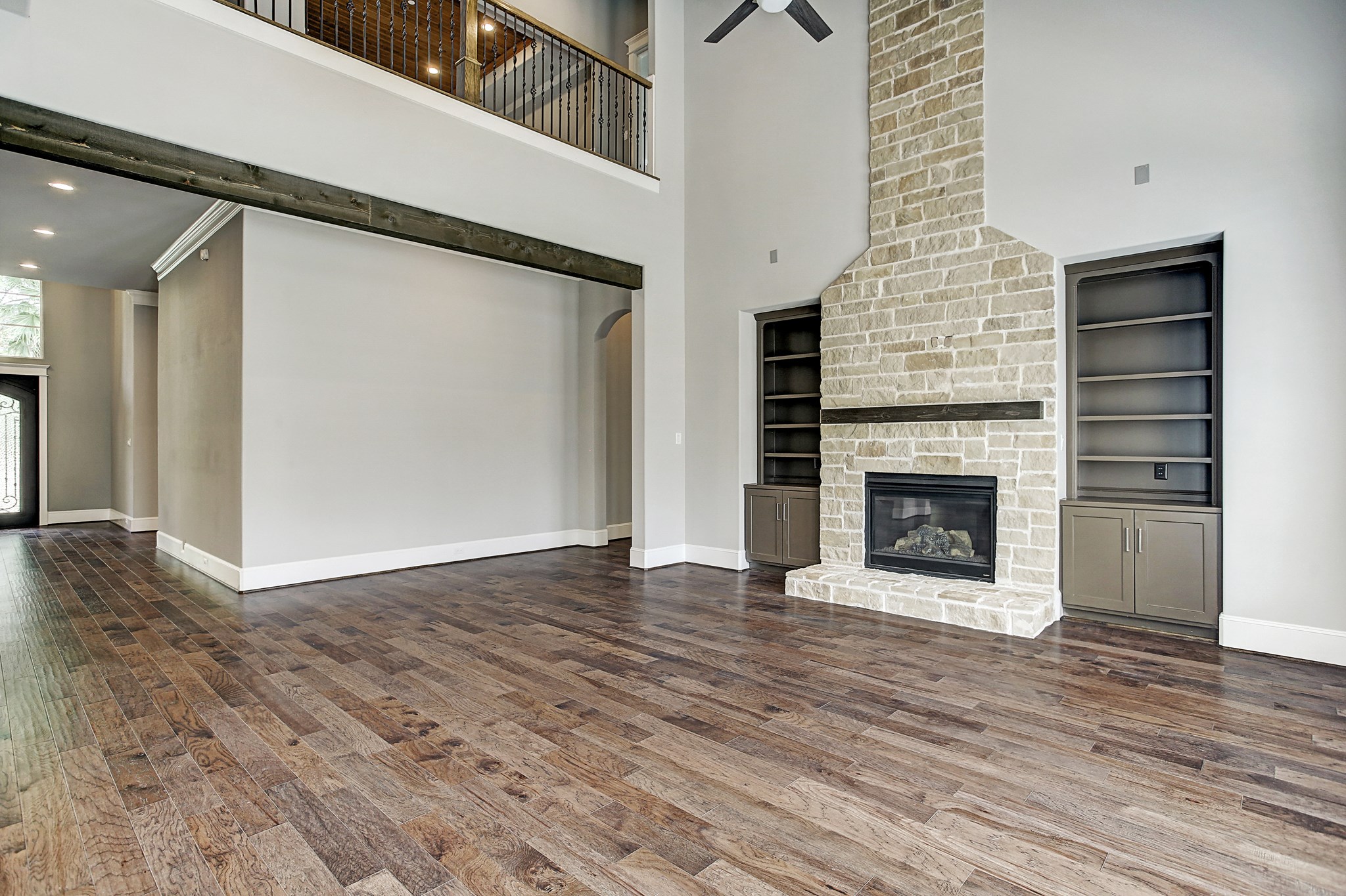 325 Bunker Hill Road Houston, TX 77024 - Photo 9 of 50 an empty room with wooden floor a fireplace