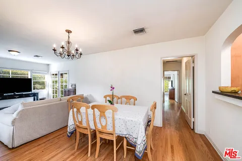a view of a dining room with furniture wooden floor and chandelier