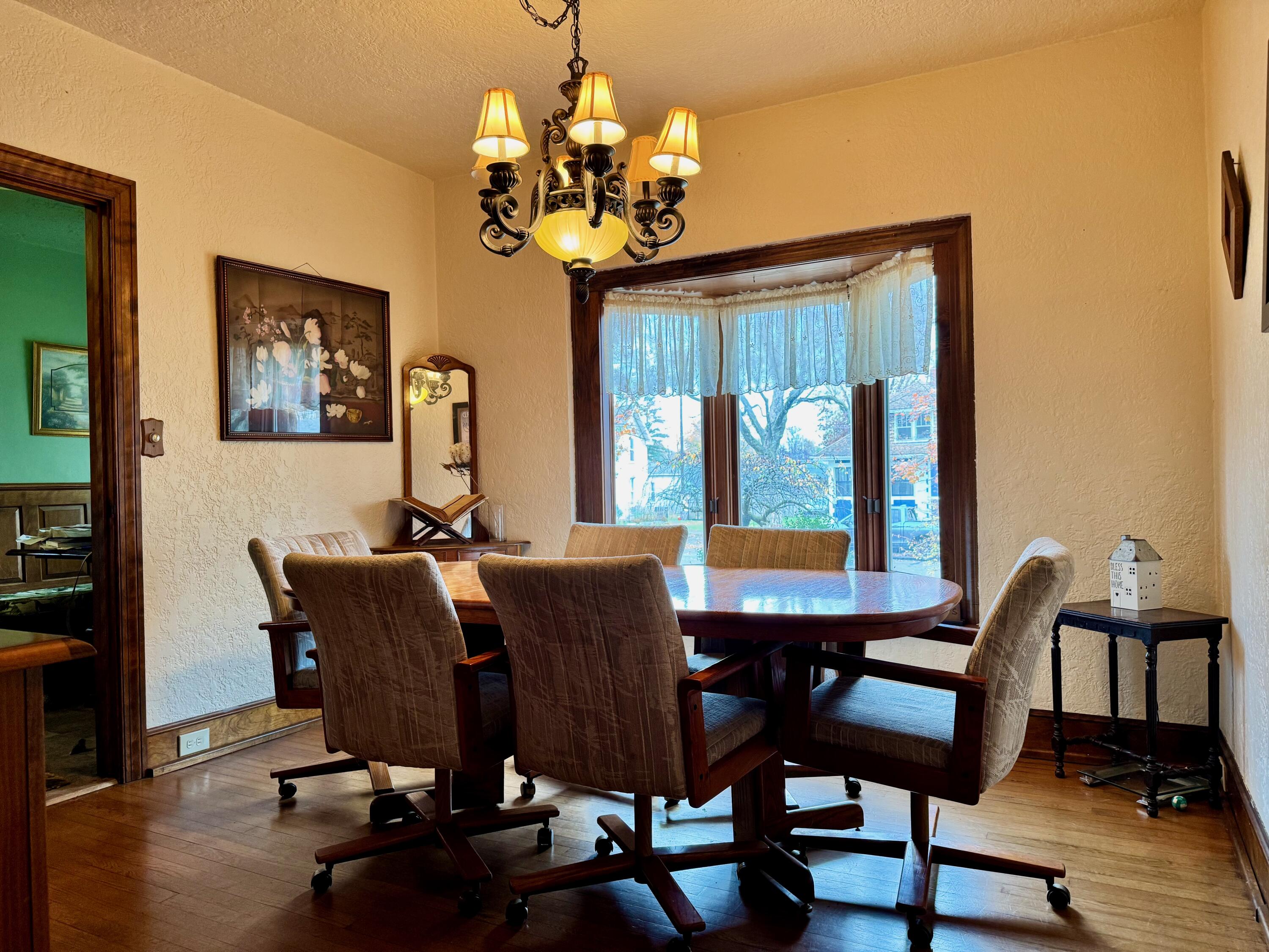 703 South Main Street Knox, IN 46534 - Photo 15 of 32 a view of a dining room with furniture wooden floor and chandelier