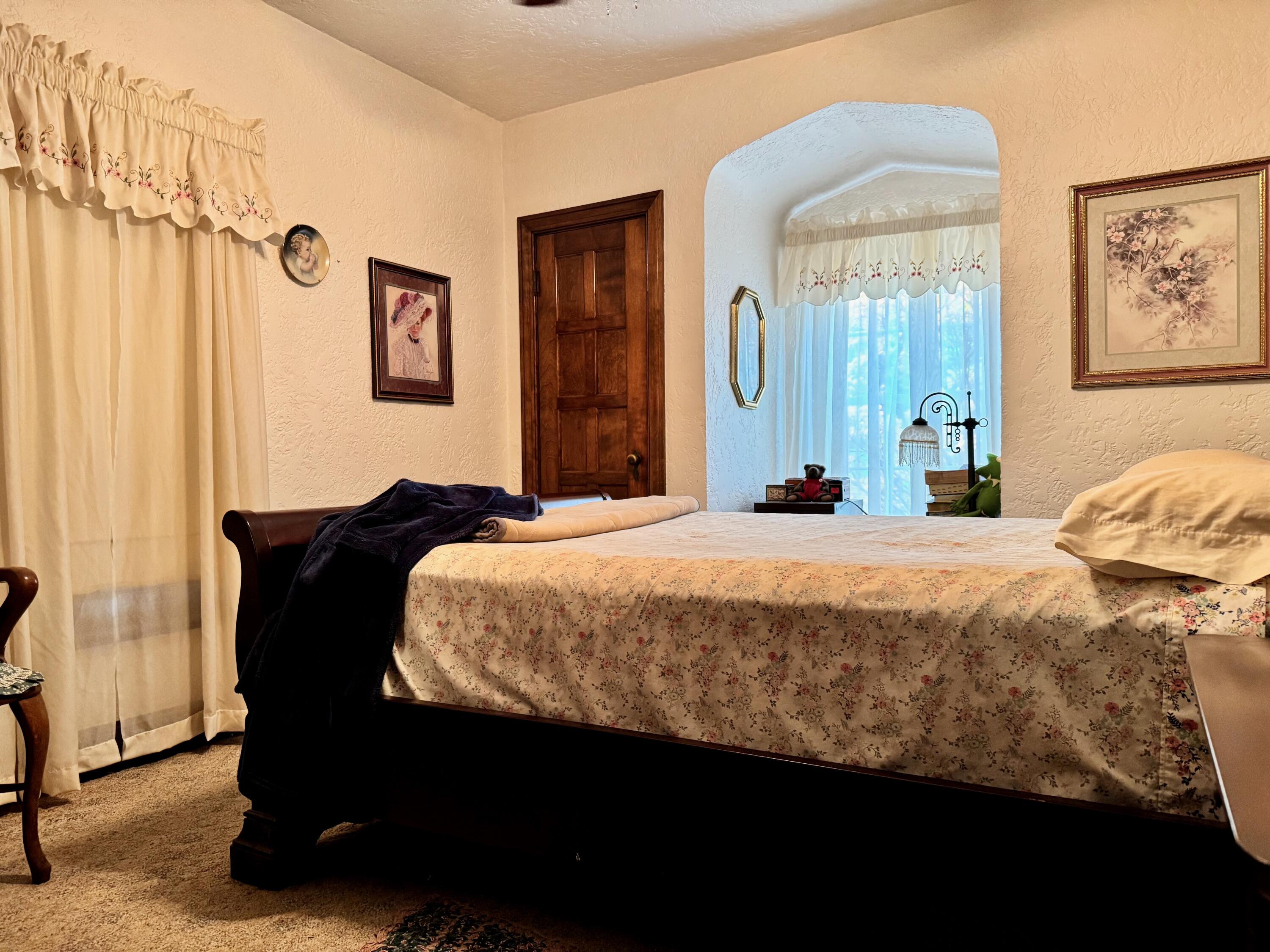 703 South Main Street Knox, IN 46534 - Photo 18 of 32 a bedroom with a bed and wooden floor