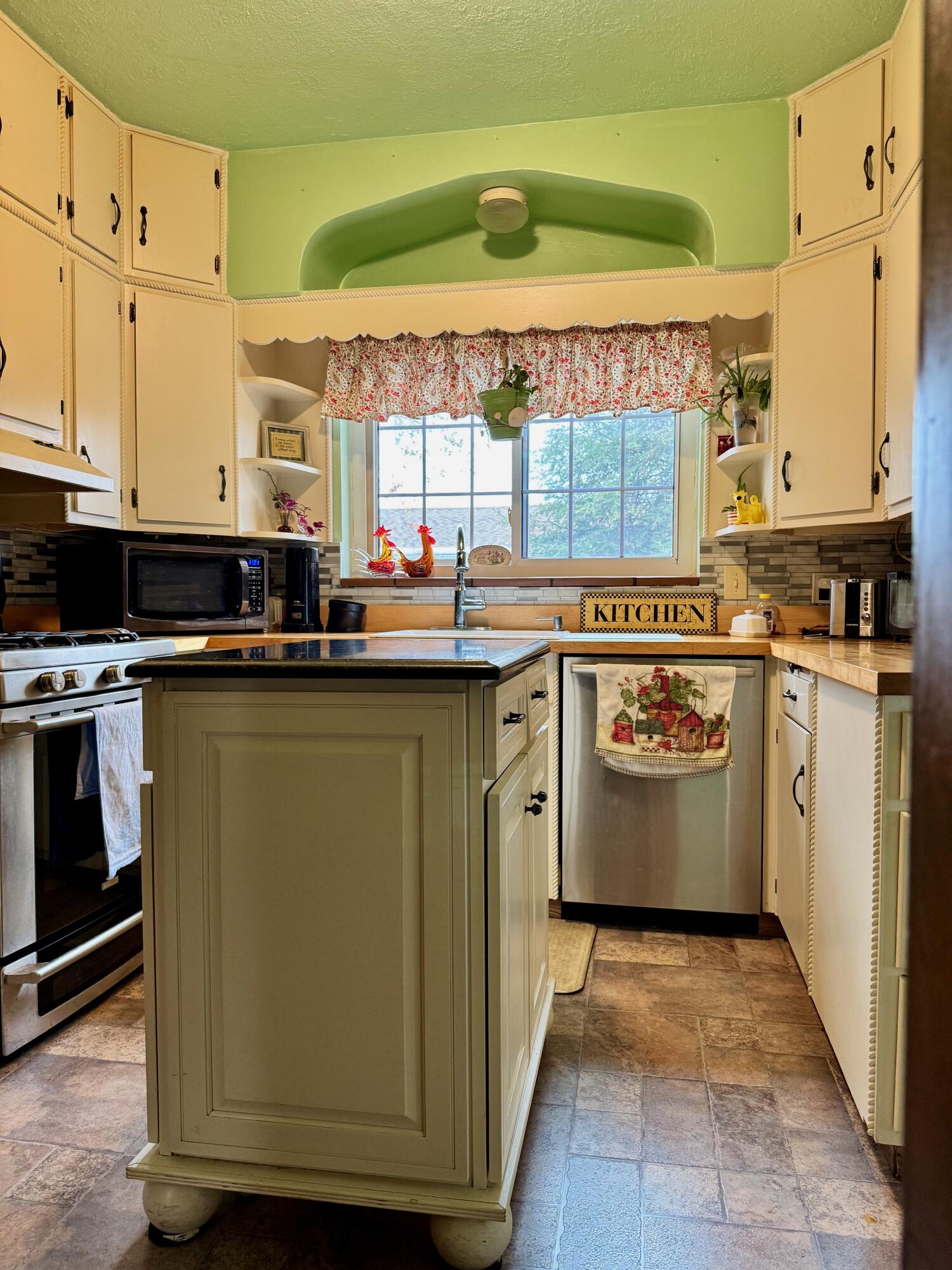 703 South Main Street Knox, IN 46534 - Photo 7 of 32 a kitchen with a sink stove and cabinets