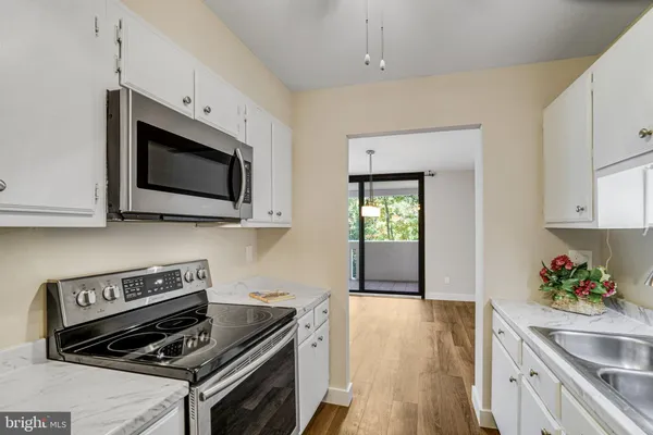 a kitchen with stainless steel appliances a sink stove and refrigerator