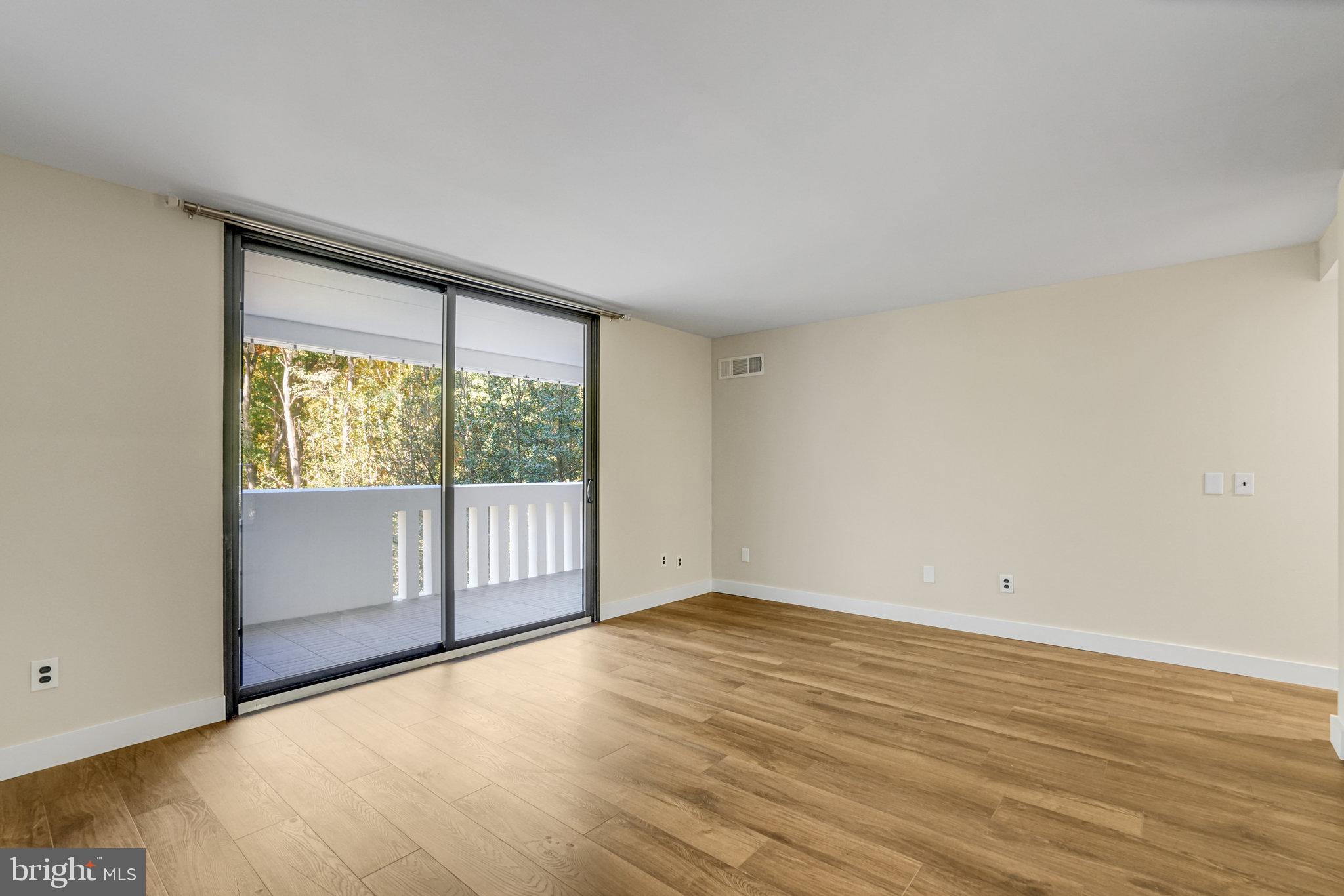 6101 Edsall Road, Unit 312 Alexandria, VA 22304 - Photo 18 of 57 a view of an empty room with wooden floor and a window