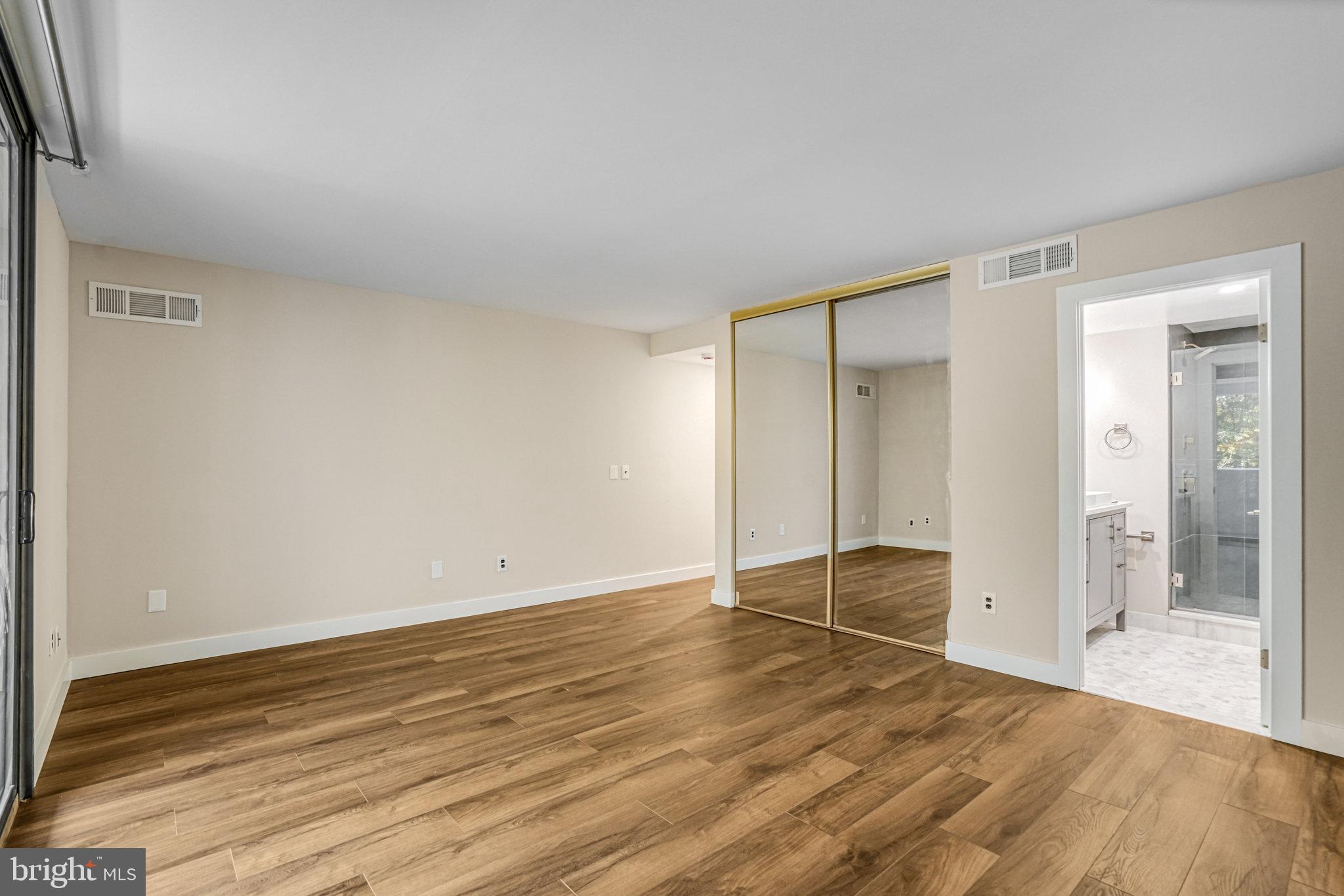6101 Edsall Road, Unit 312 Alexandria, VA 22304 - Photo 20 of 57 a view of an empty room and wooden floor and a window