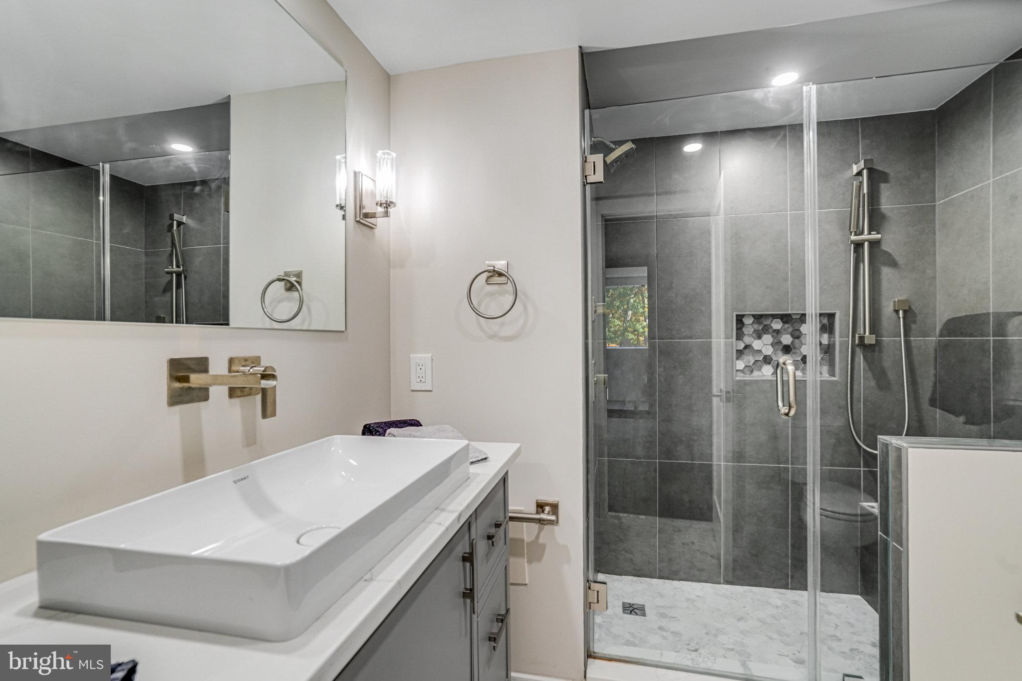 6101 Edsall Road, Unit 312 Alexandria, VA 22304 - Photo 21 of 57 a bathroom with a sink a toilet and shower