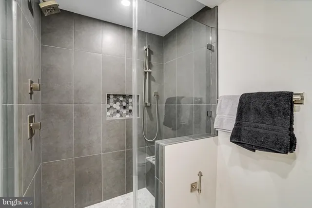 a view of a room with wooden floor and a hallway