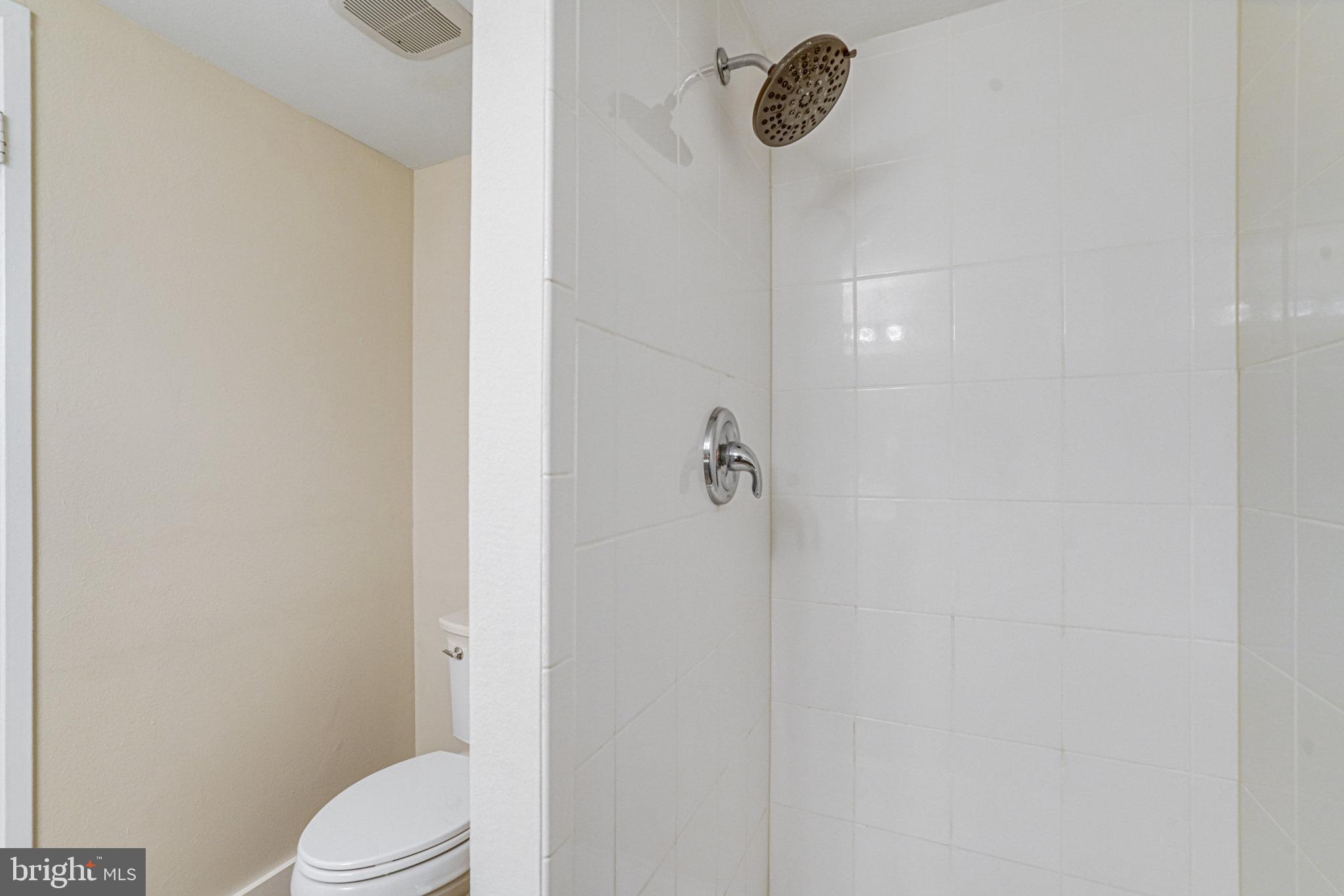 6101 Edsall Road, Unit 312 Alexandria, VA 22304 - Photo 28 of 57 a white toilet sitting next to a shower