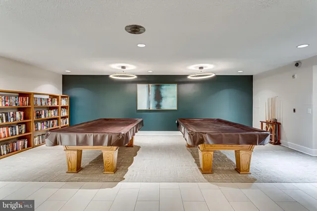 a living room with couches chairs and kitchen view with wooden floor