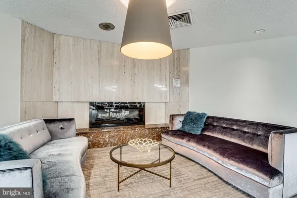 a living room with furniture and a lamp