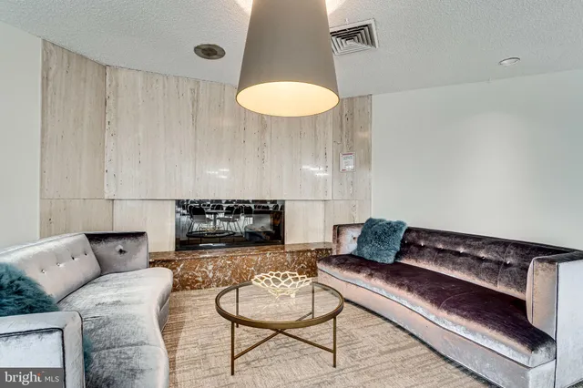 a living room with furniture and a lamp