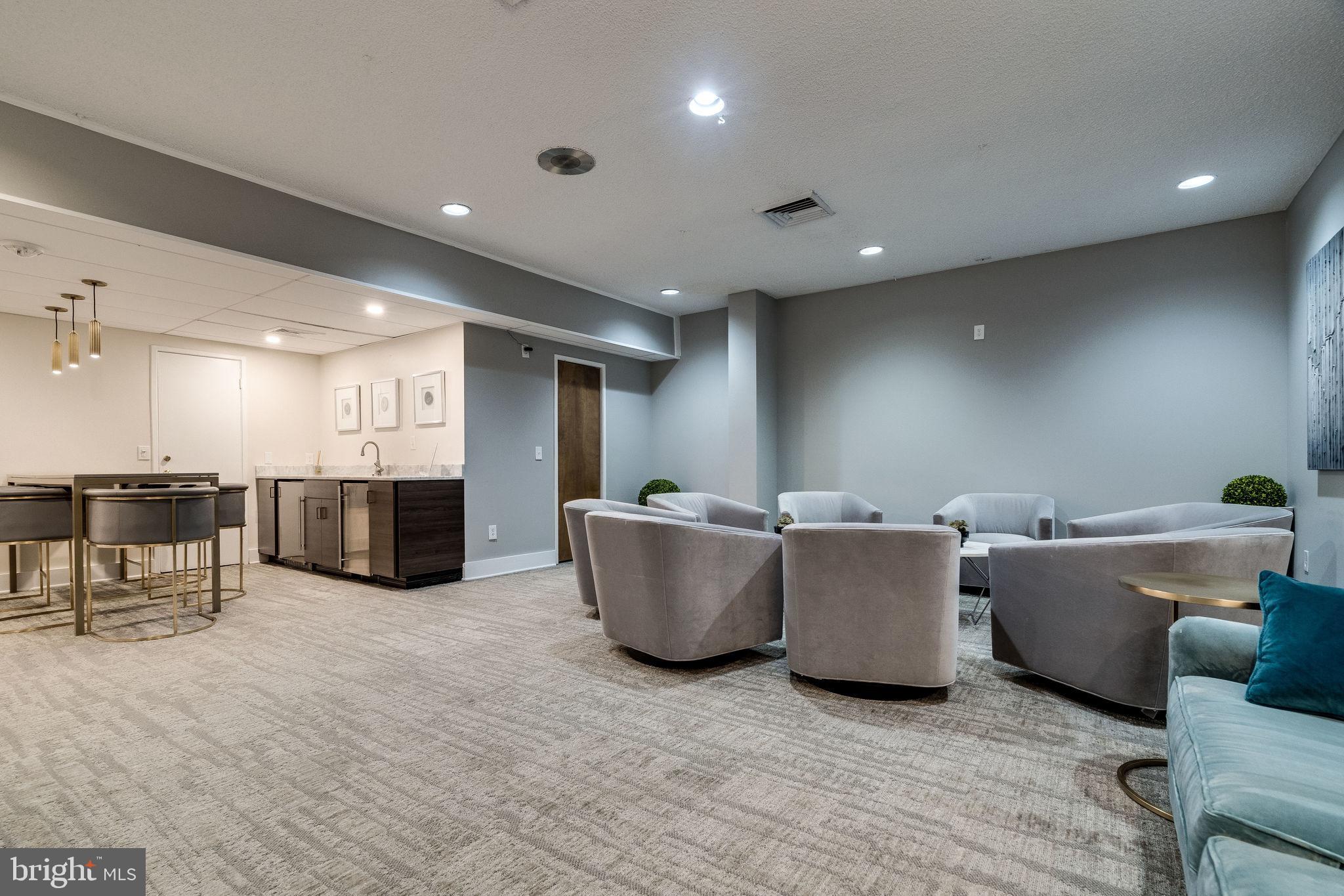 6101 Edsall Road, Unit 312 Alexandria, VA 22304 - Photo 43 of 57 a living room with couches and kitchen with stainless steel appliances