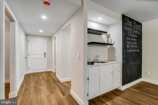 a view of a big room with wooden floor and windows