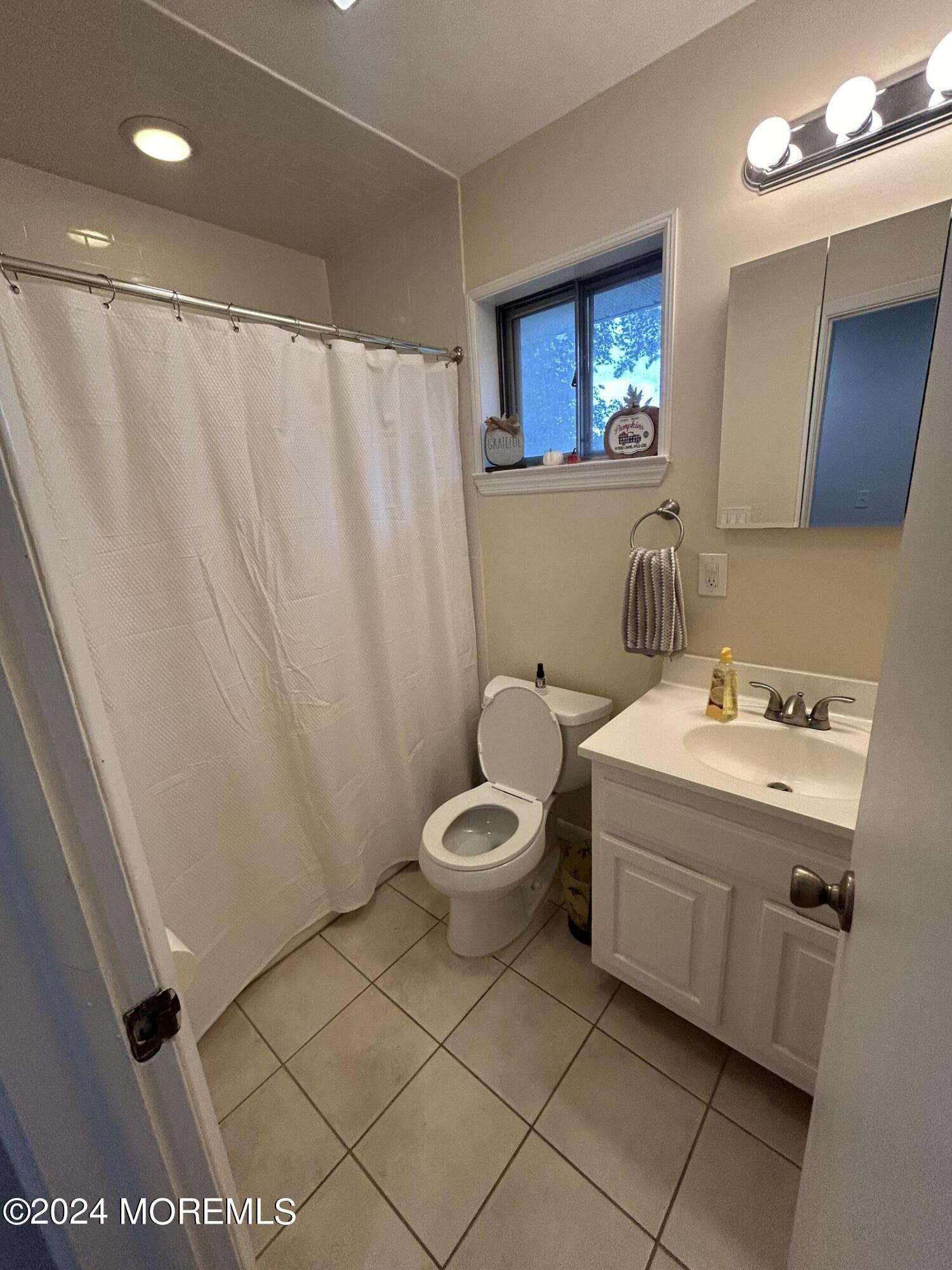 55 Fairview Drive Middletown, NJ 07748 - Photo 8 of 18 a bathroom with a toilet sink and mirror