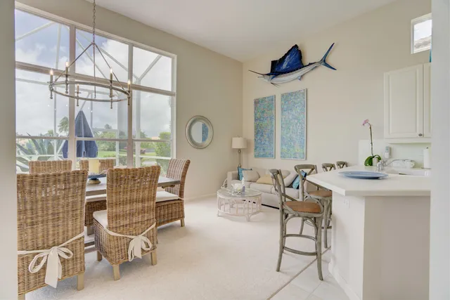a living room with furniture a window and a chandelier