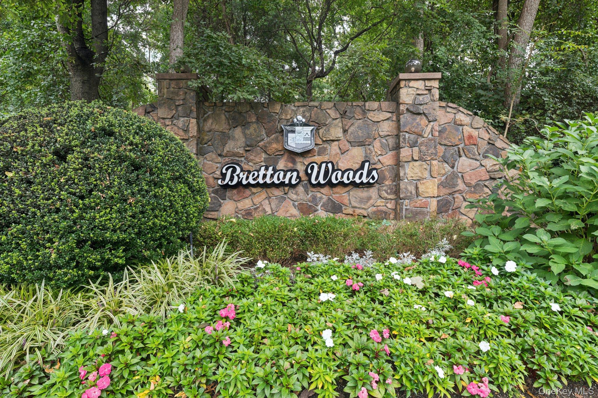 a sign that is sitting in front of flowers