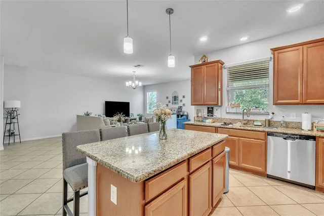 a kitchen with a stove a sink a dining table and chairs