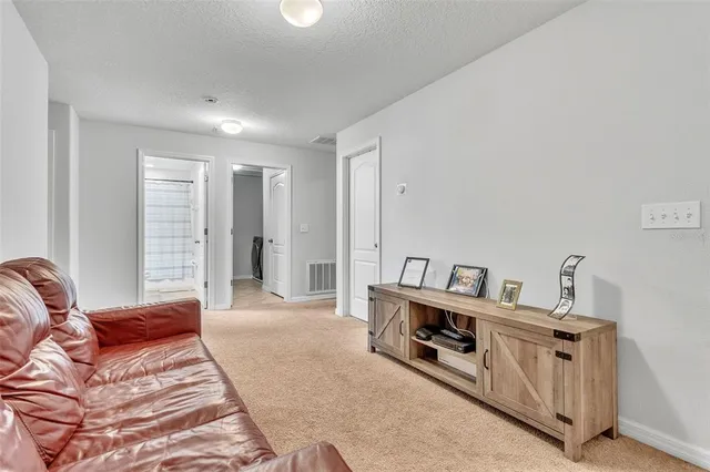 a spacious bedroom with a bed a couch and dresser