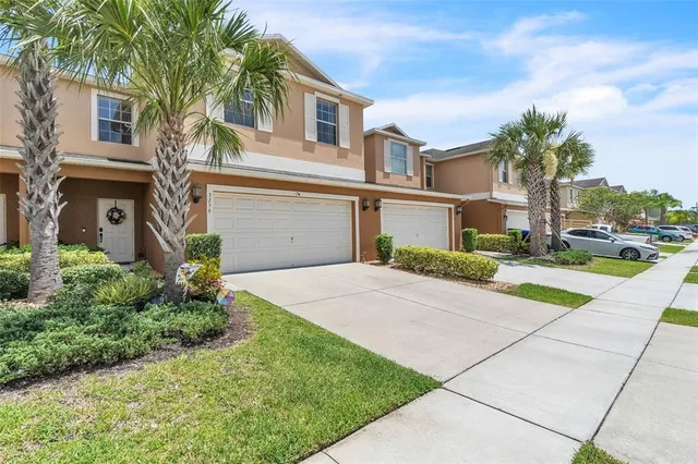 a front view of a house with a yard and a garage