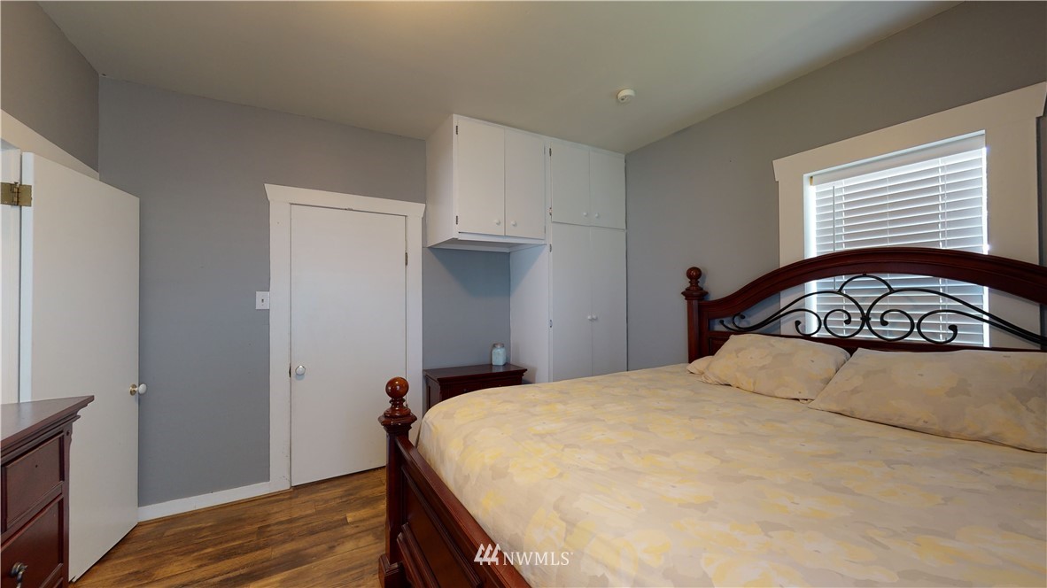 17815 Dunbar Road Mount Vernon, WA 98273 - Photo 22 of 29 a bedroom with a bed and wooden floor