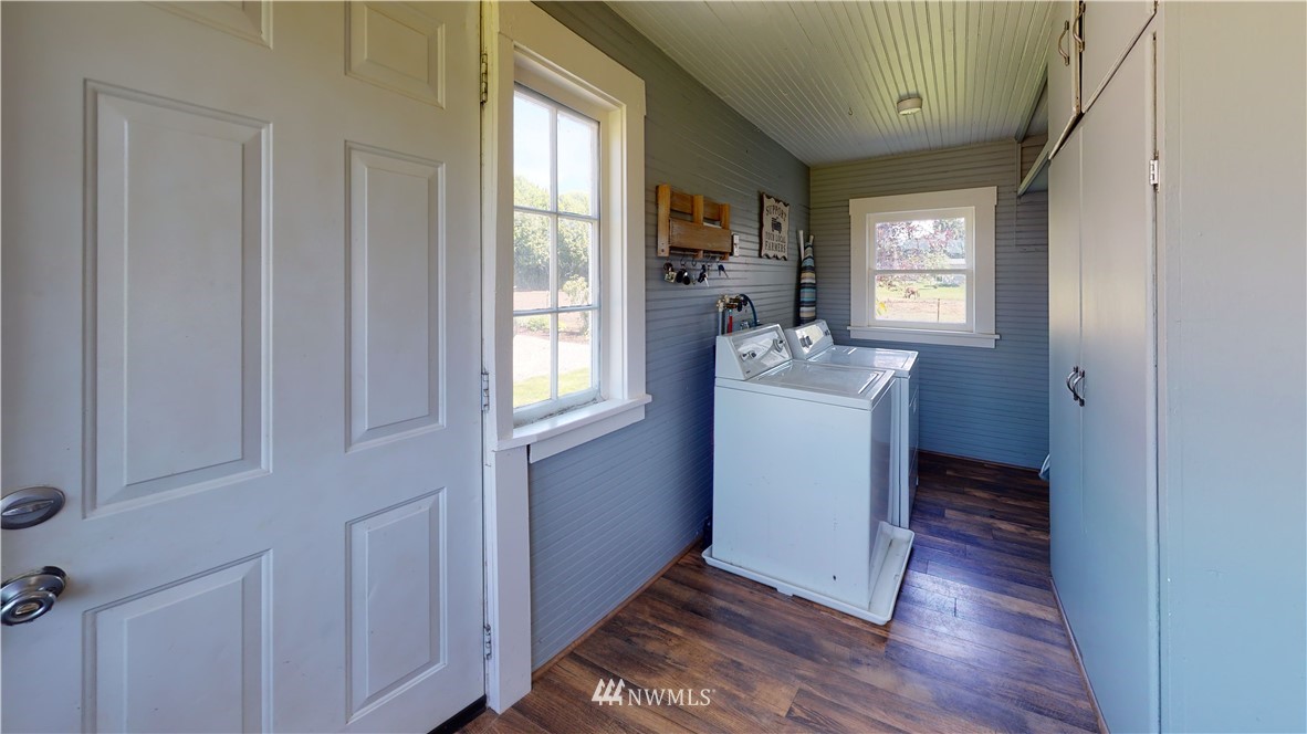 17815 Dunbar Road Mount Vernon, WA 98273 - Photo 28 of 29 a room with a sink and mirror with wooden floor