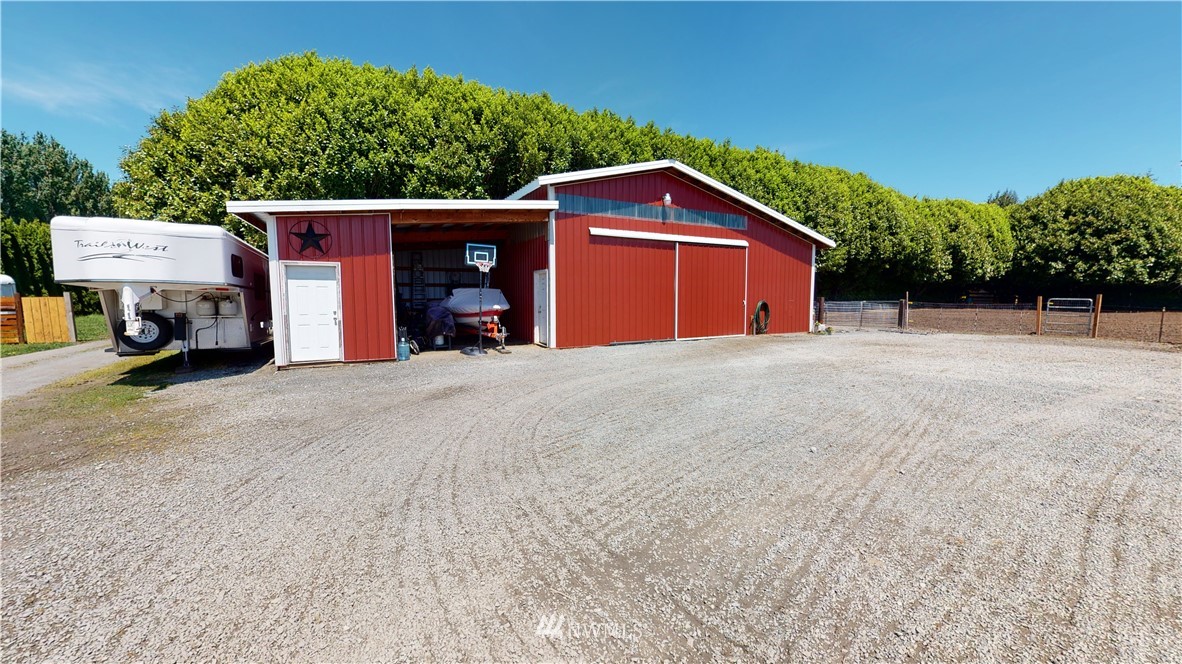17815 Dunbar Road Mount Vernon, WA 98273 - Photo 9 of 29 a view of a house with a yard and garage