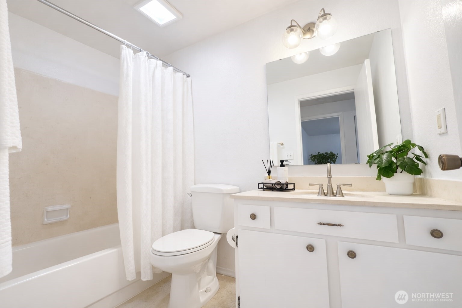 318 South 174th Place, Unit K Burien, WA 98148 - Photo 5 of 12 a bathroom with a sink a toilet and a mirror