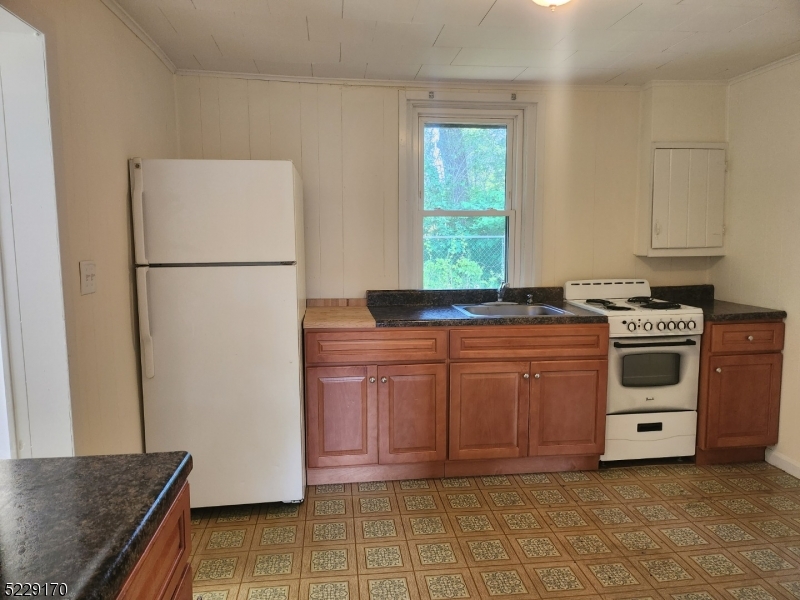 374 Rte 24 Chester, NJ 07930 - Photo 6 of 15 a kitchen with a stove a sink and a refrigerator