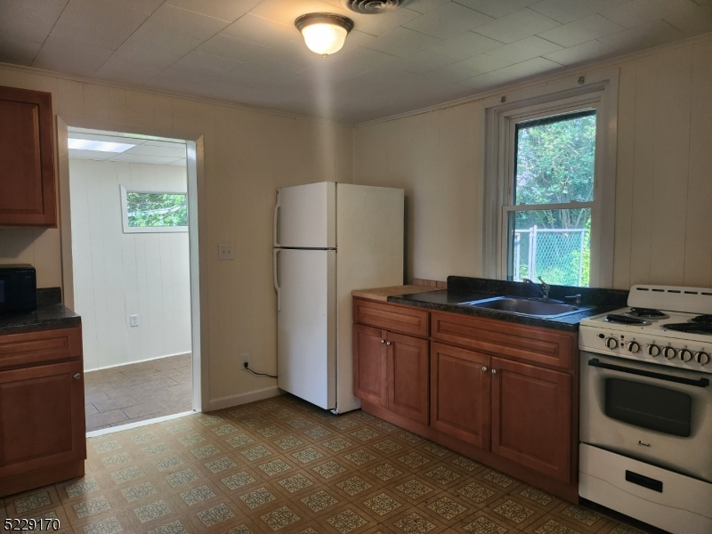 374 Rte 24 Chester, NJ 07930 - Photo 7 of 15 a kitchen with stainless steel appliances granite countertop a stove a refrigerator and a stove