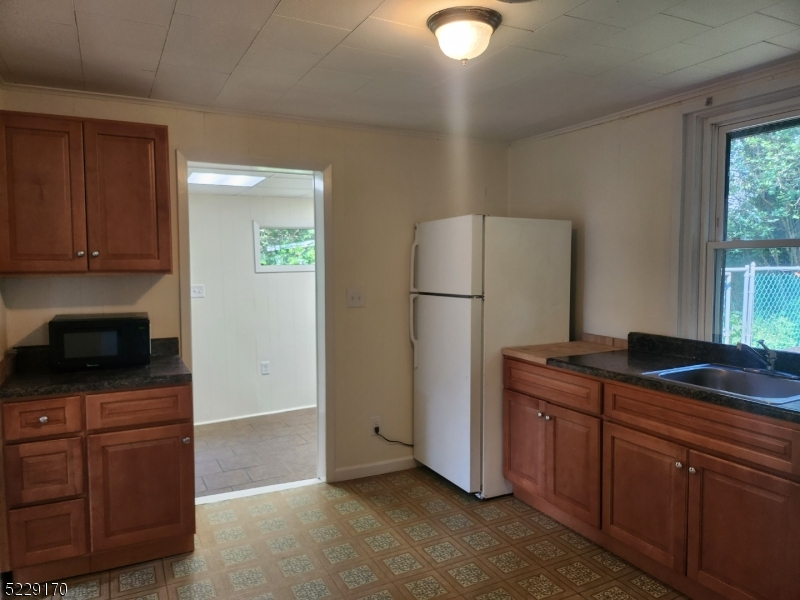 374 Rte 24 Chester, NJ 07930 - Photo 8 of 15 a kitchen with kitchen island granite countertop cabinets and refrigerator