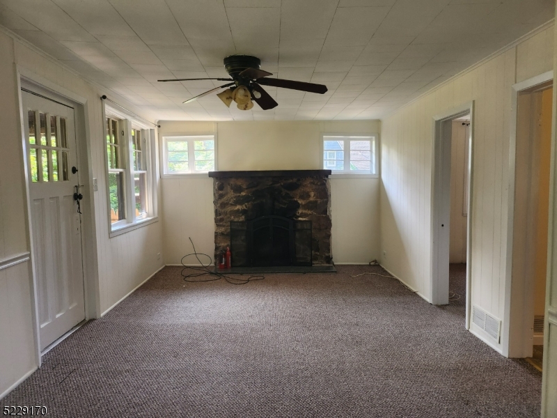 374 Rte 24 Chester, NJ 07930 - Photo 9 of 15 en empty room with windows and ceiling fan