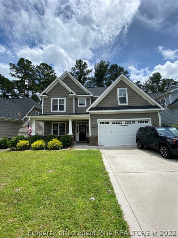 144 Moultrie Lane Aberdeen, NC 28315 - Photo 1 of 49 a front view of a house with a garden