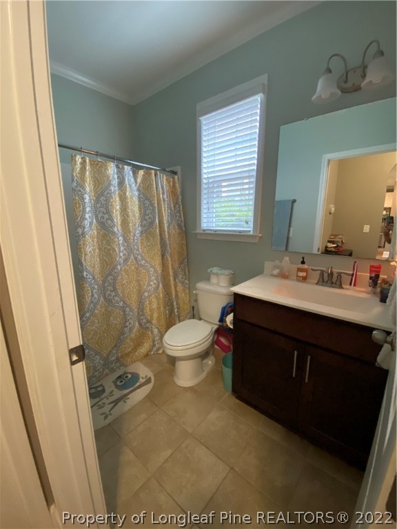 144 Moultrie Lane Aberdeen, NC 28315 - Photo 19 of 49 a bathroom with a sink a toilet a mirror and shower