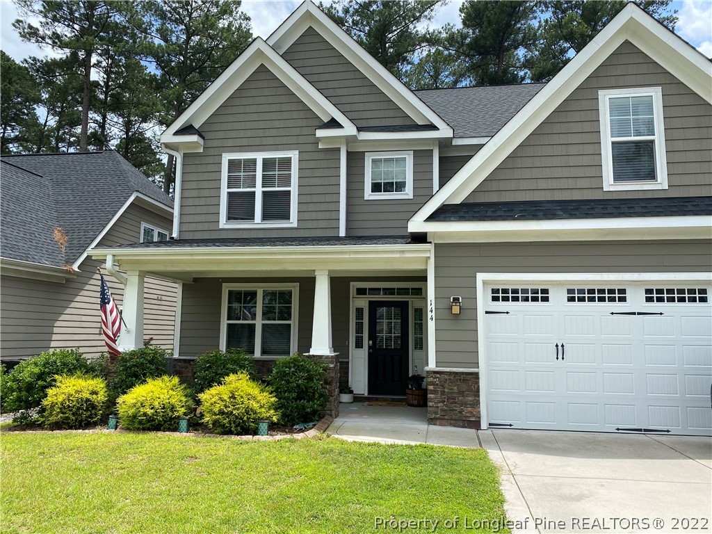 144 Moultrie Lane Aberdeen, NC 28315 - Photo 2 of 49 a front view of a house with a yard and potted plants