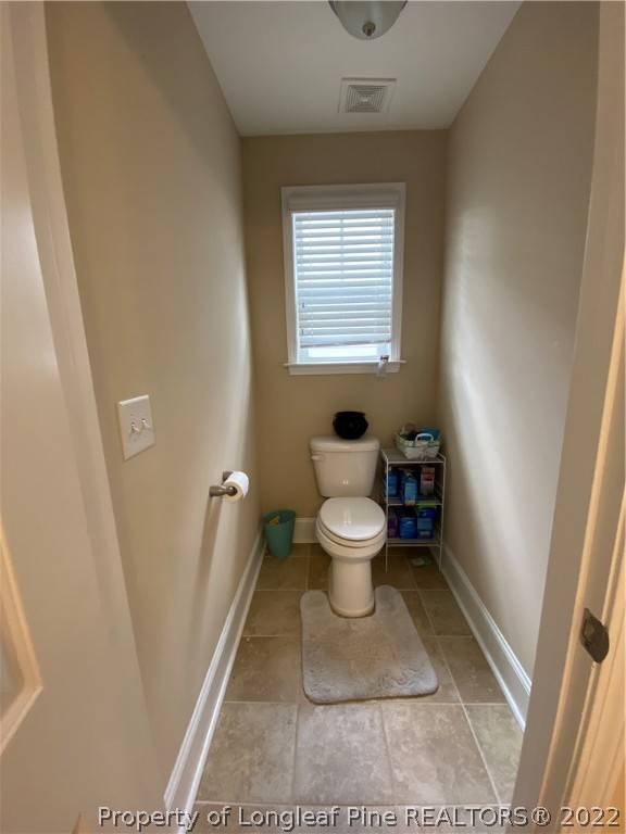 144 Moultrie Lane Aberdeen, NC 28315 - Photo 28 of 49 a bathroom with a toilet and a window