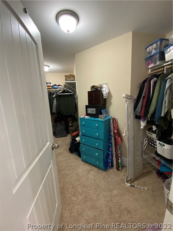 144 Moultrie Lane Aberdeen, NC 28315 - Photo 29 of 49 a view of walk in closet with clothes and shoes