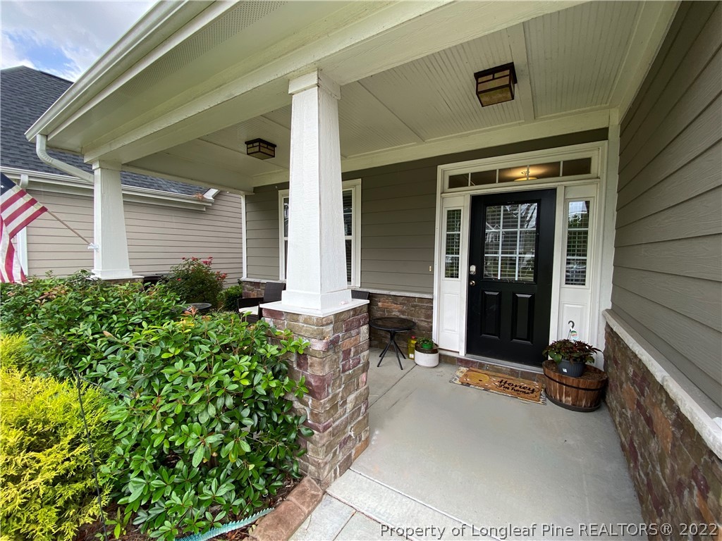 144 Moultrie Lane Aberdeen, NC 28315 - Photo 3 of 49 a house with potted plants in front of door