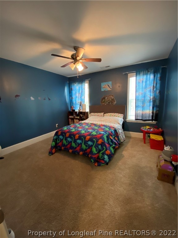144 Moultrie Lane Aberdeen, NC 28315 - Photo 35 of 49 a bedroom with bed window and couch