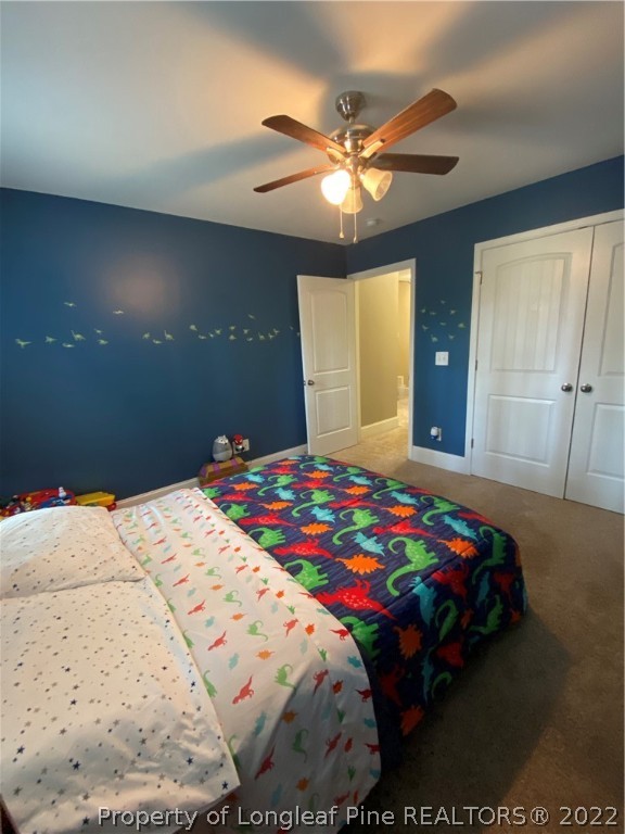 144 Moultrie Lane Aberdeen, NC 28315 - Photo 37 of 49 a bedroom with a bed and a chandelier