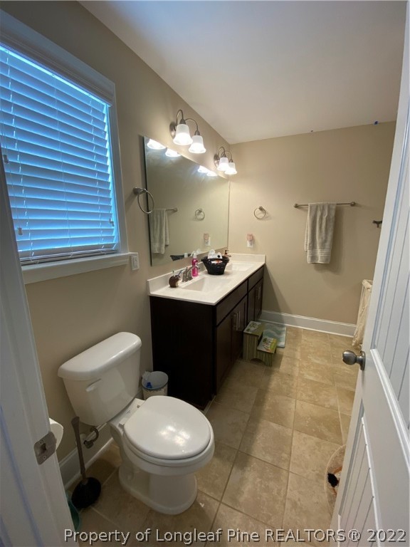 144 Moultrie Lane Aberdeen, NC 28315 - Photo 39 of 49 a bathroom with a sink toilet vanity and mirror