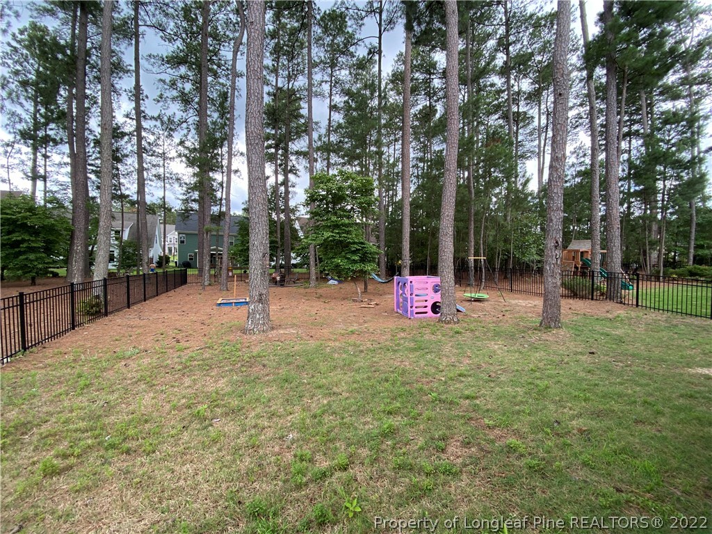 144 Moultrie Lane Aberdeen, NC 28315 - Photo 47 of 49 a backyard of a house with table and chairs