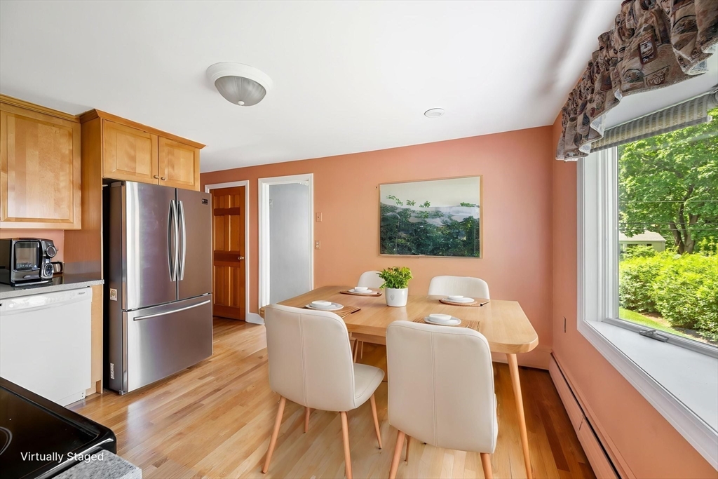 40 Bell Road Weymouth, MA 02188 - Photo 19 of 41 a dining room with furniture a window and wooden floor
