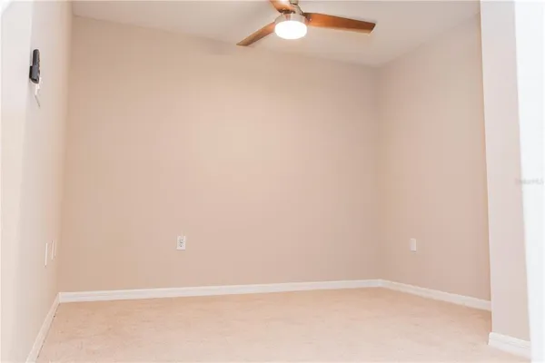 a view of empty room with a fan