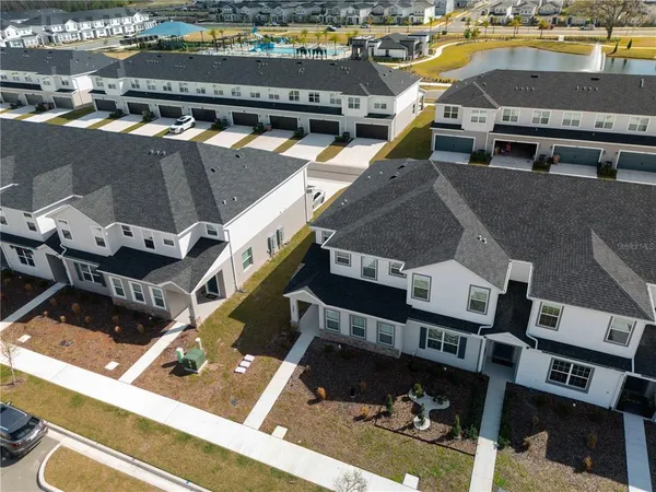 an aerial view of a house with a swimming pool
