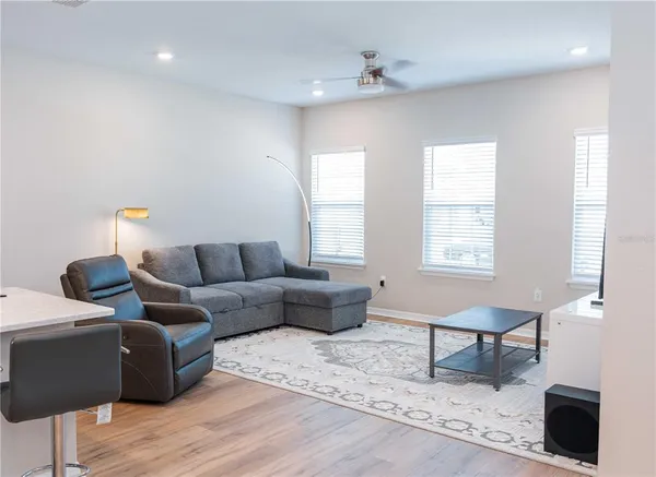 a living room with furniture and wooden floor