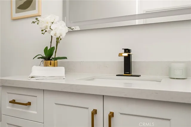 a bathroom with a sink a vanity and a mirror