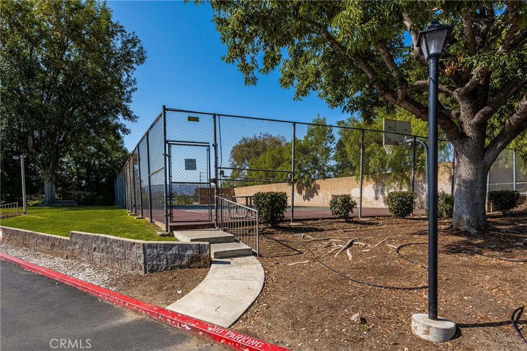 3010 Associated Road, Unit 122 Fullerton, CA 92835 - Photo 14 of 17 a view of a patio with a table and chairs under an umbrella